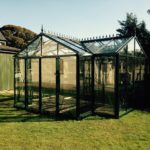 Green greenhouse on grass