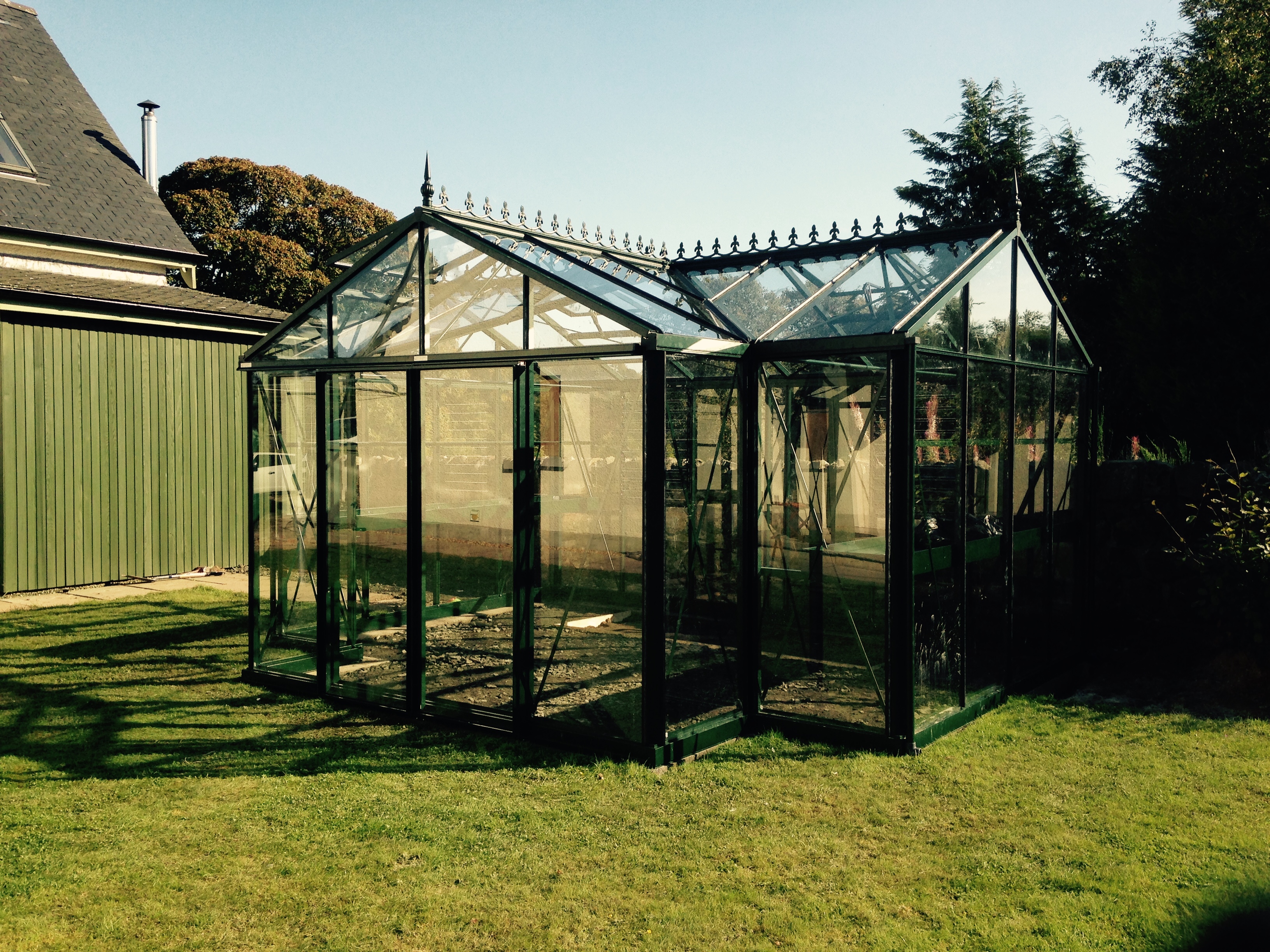 Green greenhouse on grass